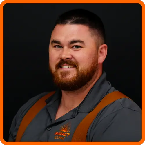 Cason Marks headshot wearing IMPACT branded gray polo and brown suspenders