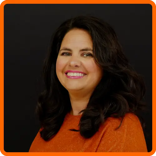 Hilton Prater headshot wearing orange blouse
