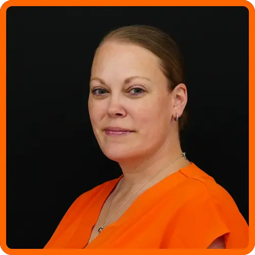 Amanda Mercado headshot wearing orange blouse